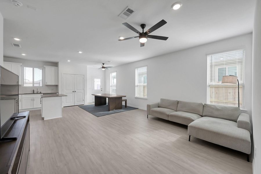 The family room and dining area includes space for a large dining table and is open to the kitchen.