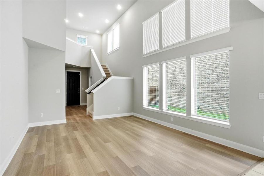 living views front door, powder bath, entrance to downstairs master suite, stairwell to 3 upstairs bedroom and living retreat
