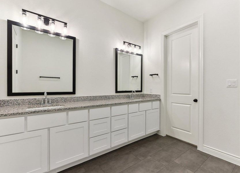 Full bathroom with tile patterned floors, double vanity, and a sink Full bathroom with tile patterned floors, double vanity, and a sink