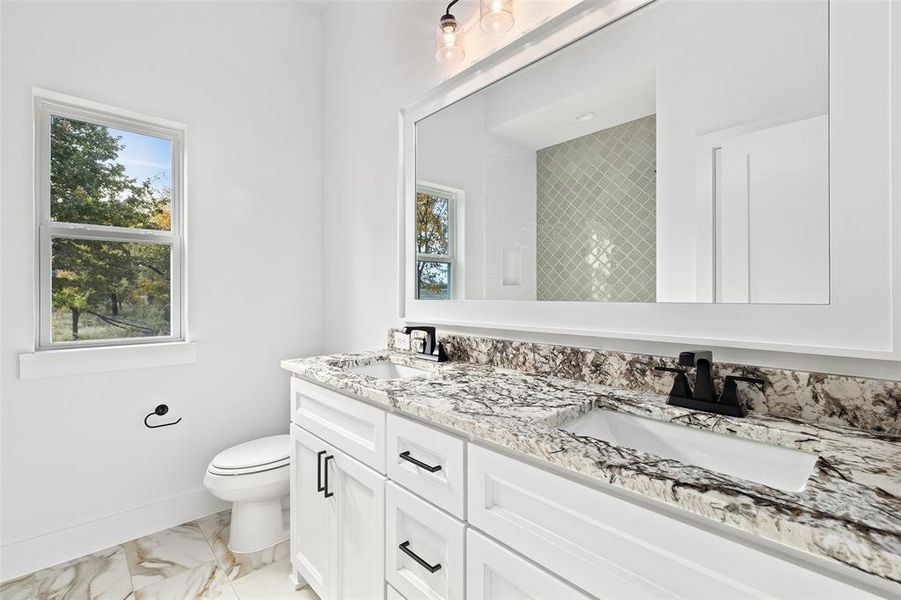 Bathroom with tile patterned flooring, vanity, and toilet