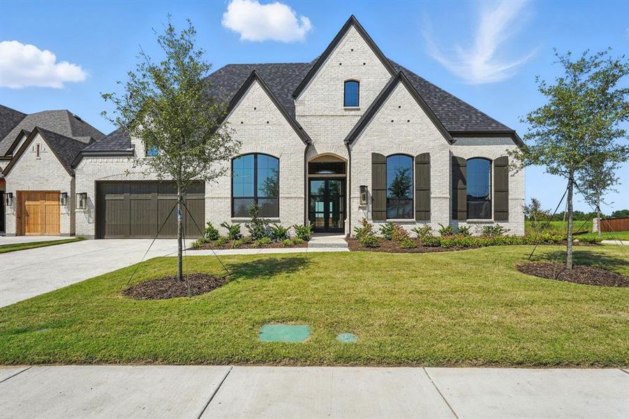 Front exterior of a new home in Saddle Star Estates, Rockwall, TX, highlighting curb appeal (Image 2).