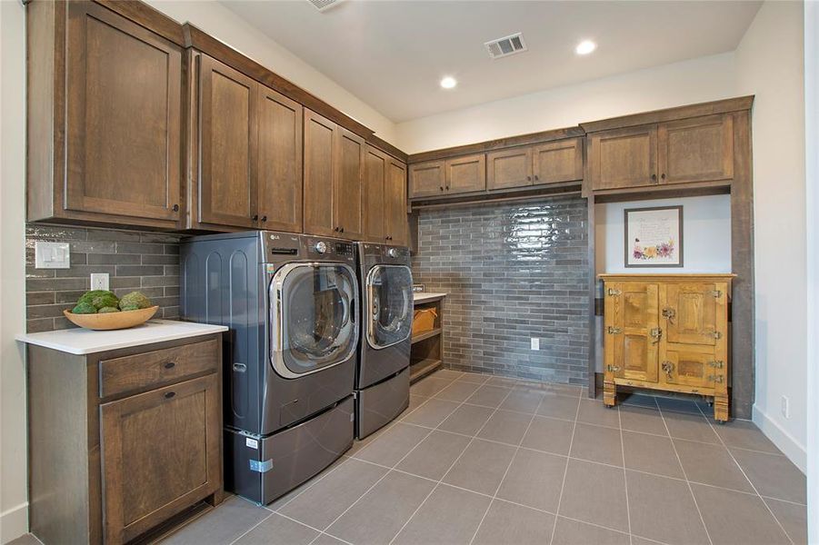 There is an abundance of cabinets & space for an extra refrigerator & freezer in the utility room.