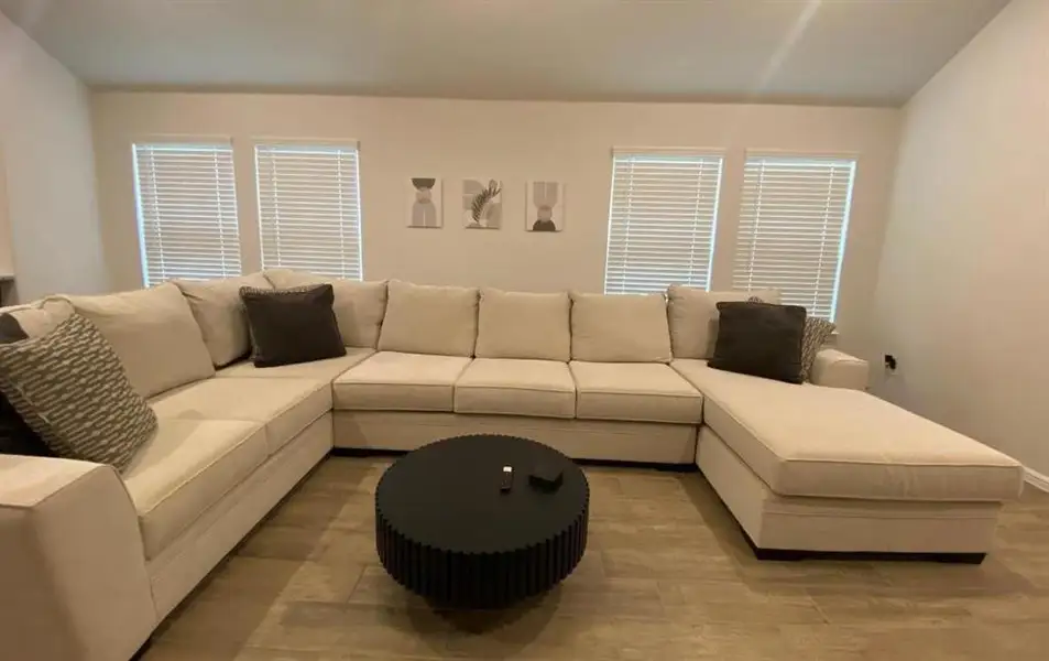 Living room with vaulted ceiling and baseboards Living room with vaulted ceiling and baseboards