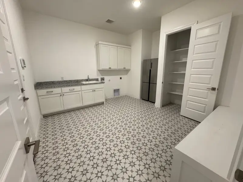 Laundry area with hookup for a washing machine, electric dryer hookup, cabinet space, and tile floors.  Mud room bench and lockers.  Nice storage closet with shelves.