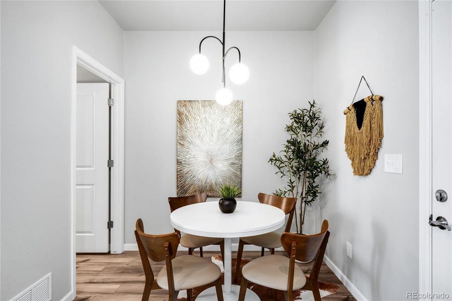 A modern new chandelier illuminates the dining space