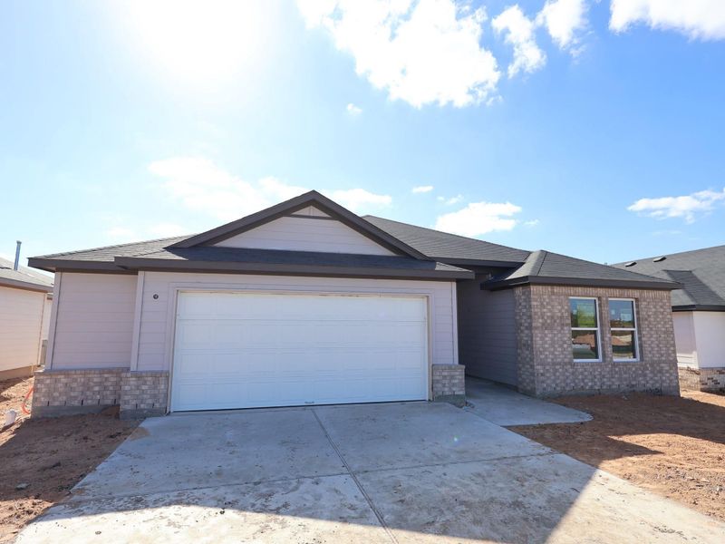 Front exterior of a new home in Carillon, Manor, TX, highlighting curb appeal (Image 1). Front exterior of a new home in Carillon, Manor, TX, highlighting curb appeal (Image 1).