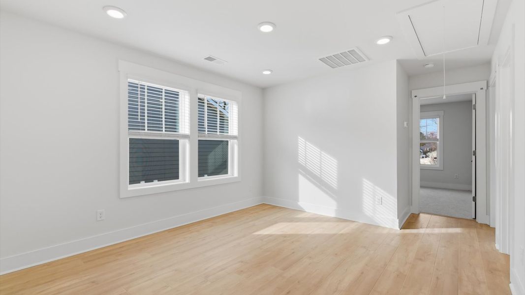 Functional loft with tasteful hardwood floors and exceptional natural light in a modern townhome