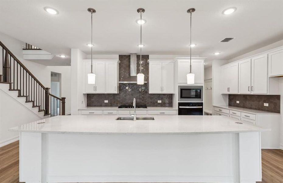 Spacious kitchen with oversized island *real home pictured