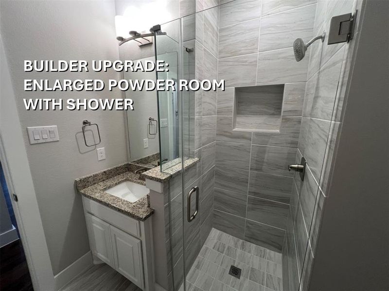 Bathroom featuring a glass-enclosed shower with tile surround and recessed niche Bathroom featuring a glass-enclosed shower with tile surround and recessed niche