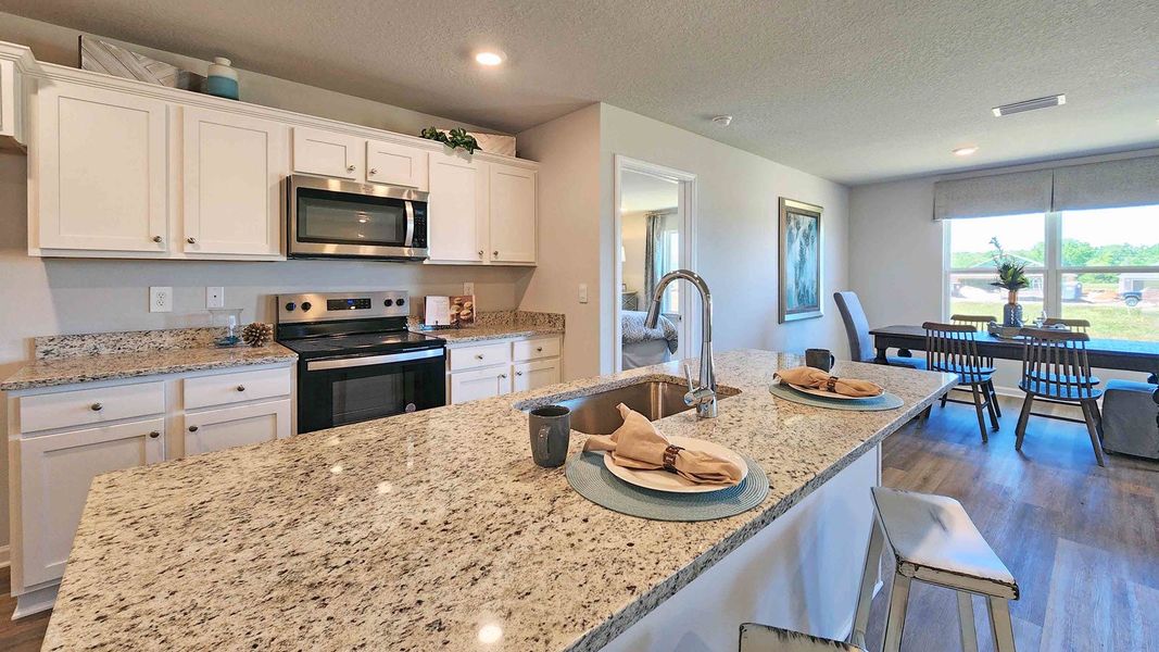 Furnished interior in a model home at Magnolia at the Bluffs Phase 3 in Freeport (Image 18).