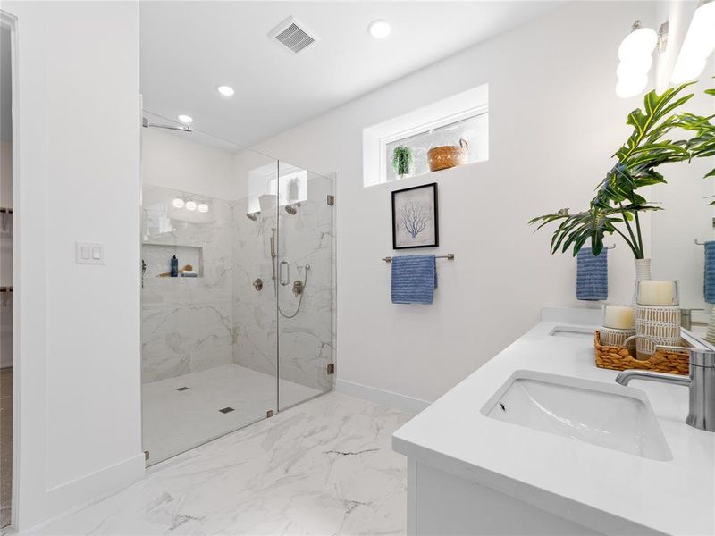 Full bathroom featuring  marble finish shower, recessed lighting, double vanity, and marble finish floors