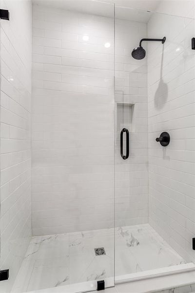 Full bath featuring a shower stall Full bath featuring a shower stall