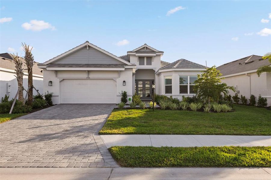 Front exterior of a new home in , Lakewood Ranch, FL, highlighting curb appeal (Image 22).