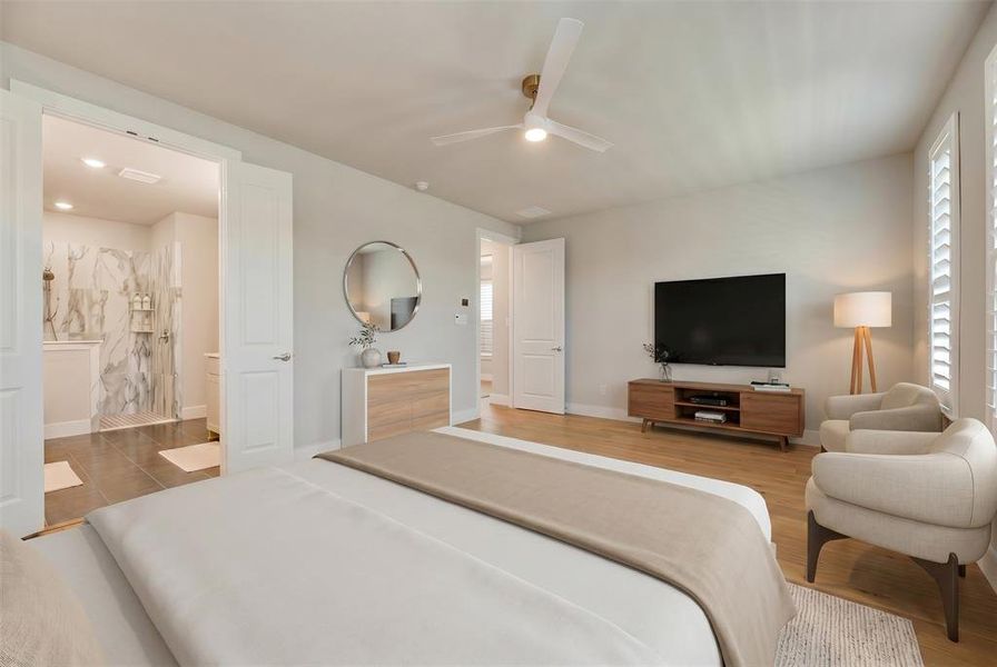 Bright sleeping area with light wood-finish flooring, a ceiling fan, and window shutters