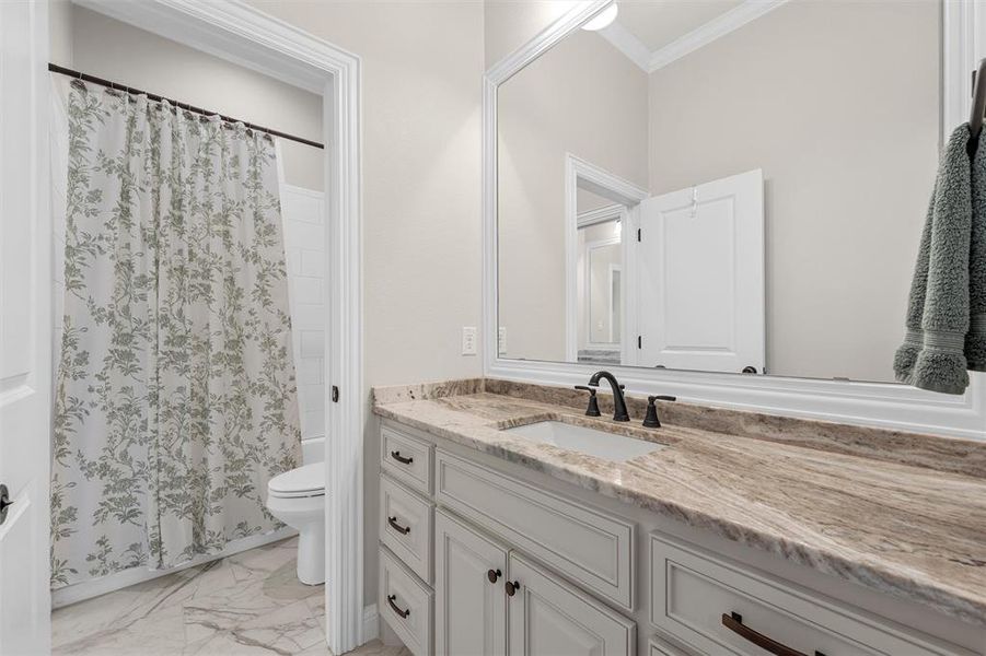 Jack and Jill bathroom featuring a tub/shower combo with a tile finish. Jack and Jill bathroom featuring a tub/shower combo with a tile finish.