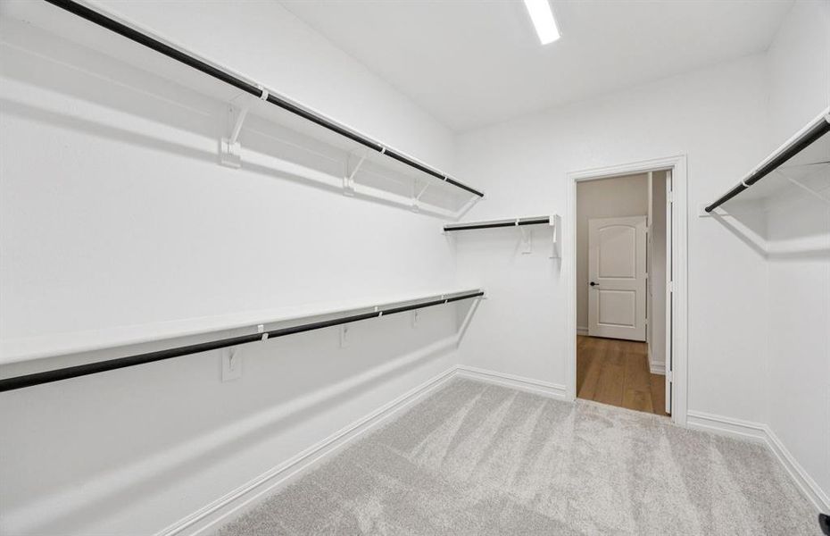 Expansive owner's closet designed for optimal organization Expansive owner's closet designed for optimal organization