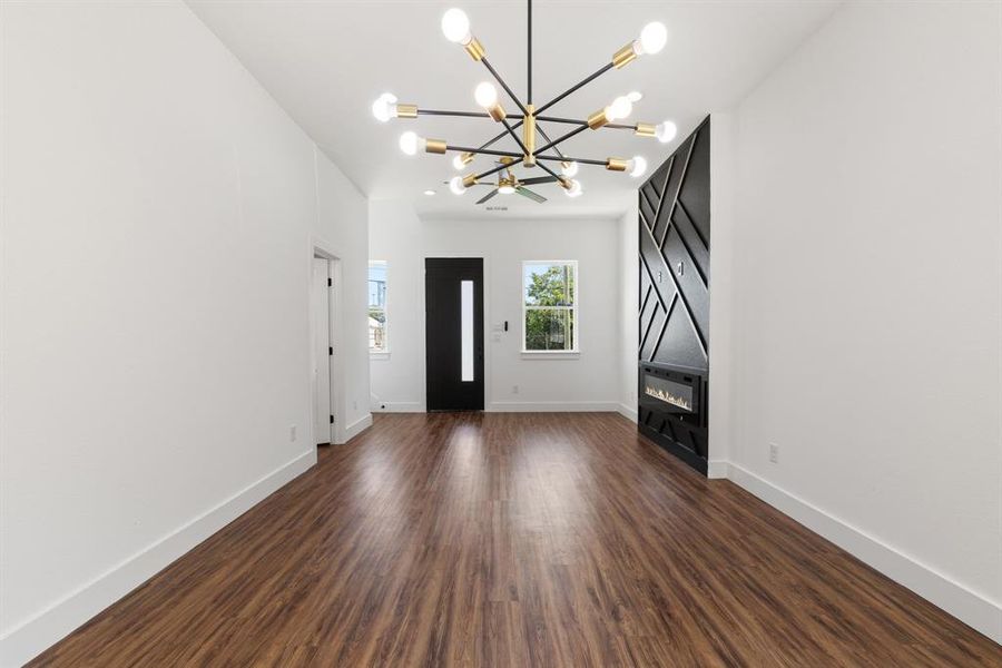 Entryway with dark wood-type flooring, a chandelier, and recessed lighting