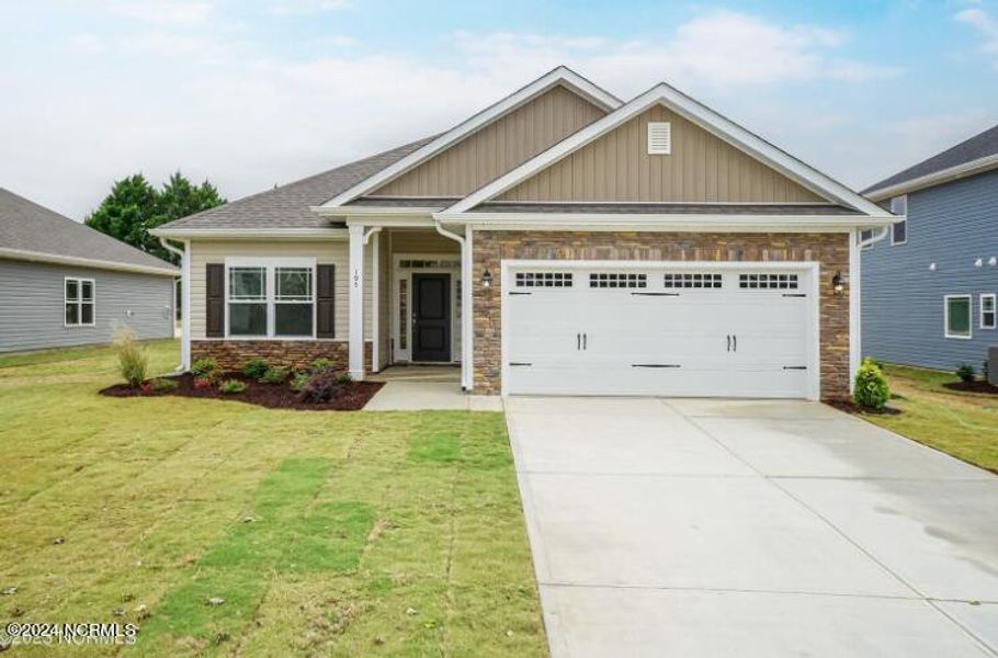 Front exterior of a new home in River Village Square in River Landing, Wallace, NC, highlighting curb appeal (Image 2).