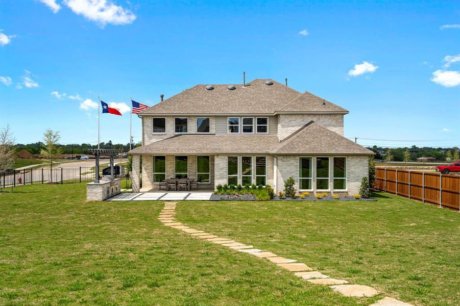 Back of house with a patio area and a yard