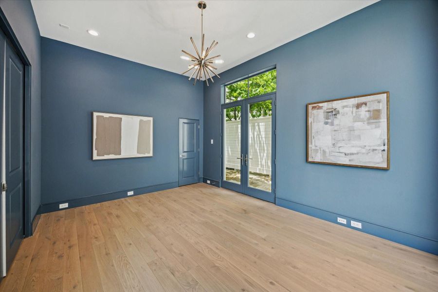 Designer light fixture, spacious closet, and pocket doors complete this spacious room.