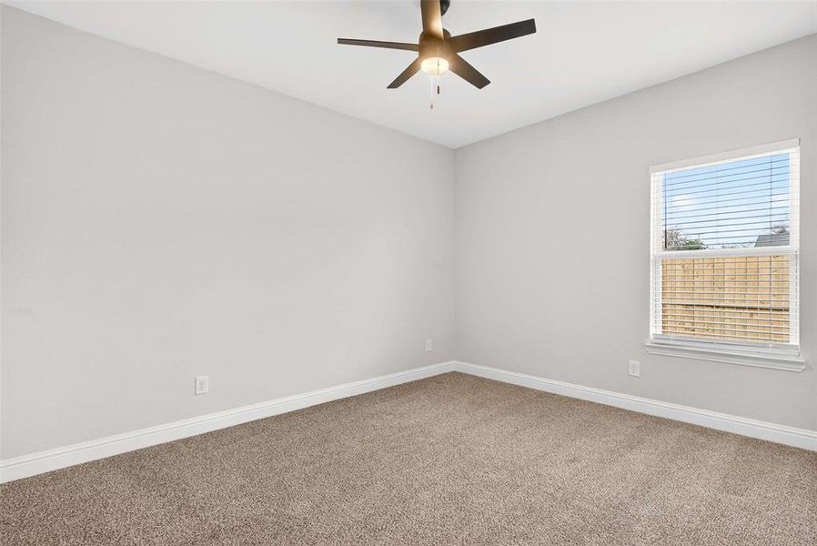Unfurnished room with carpet and ceiling fan