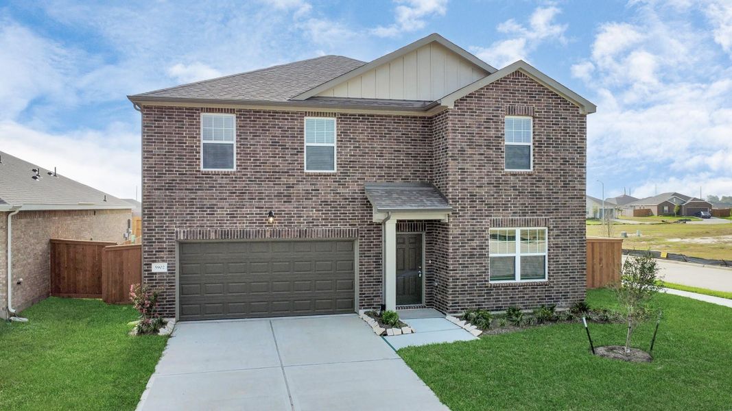 Front exterior of a new home in Sunterra, Katy, TX, highlighting curb appeal (Image 22).