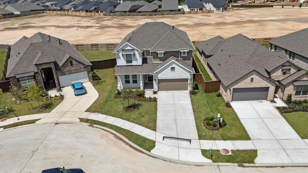 Front exterior of a new home in The Trails, New Caney, TX, highlighting curb appeal (Image 16).