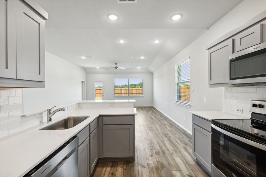 Kitchen in the Sapphire home plan by Trophy Signature Homes – REPRESENTATIVE PHOTO