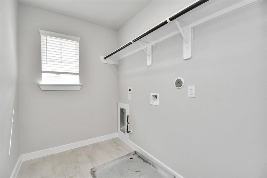 Stylish laundry room where practicality meets a contemporary aesthetic. The dark finishes lend a sophisticated touch, creating a space that is both functional and visually appealing. Both electric and gas connections available.