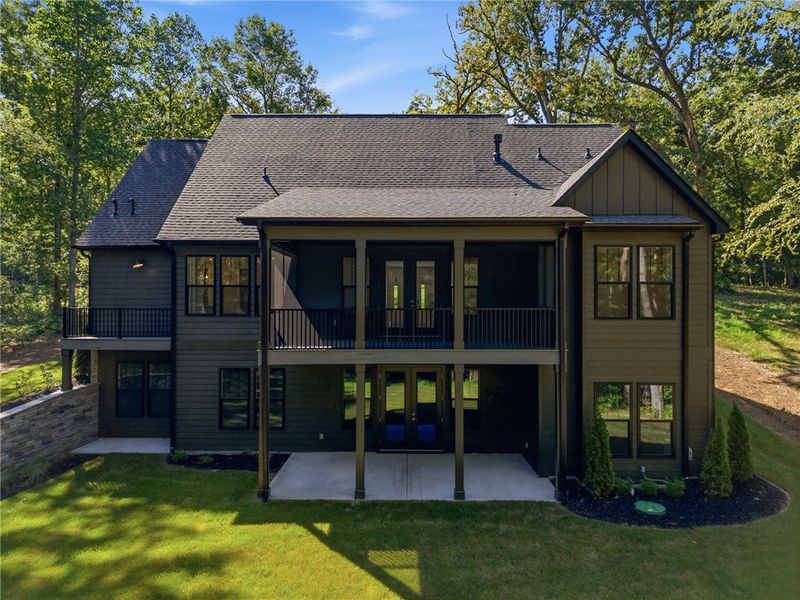A spacious covered deck and patio overlook the lus