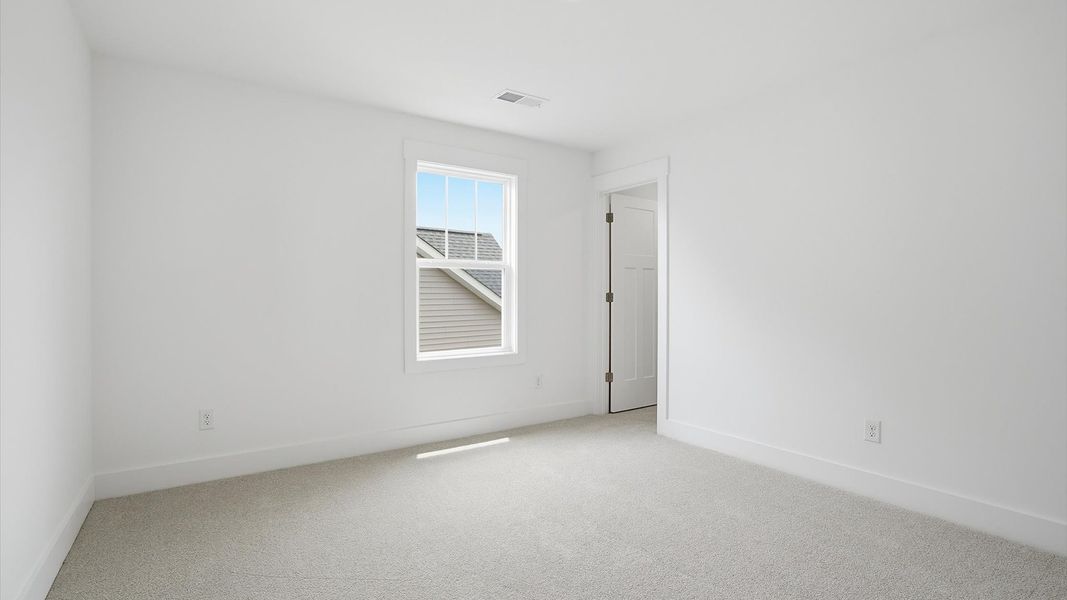 Refined bedroom design with large windows for daylight-filled mornings and peaceful views