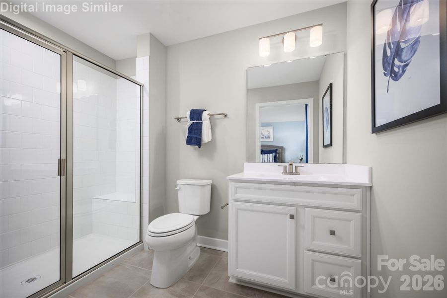 Clean lines and smart design create a space that's both spacious and soothing. The standout feature - a framed shower door that adds a touch of sophistication while keeping the space feeling open and airy.