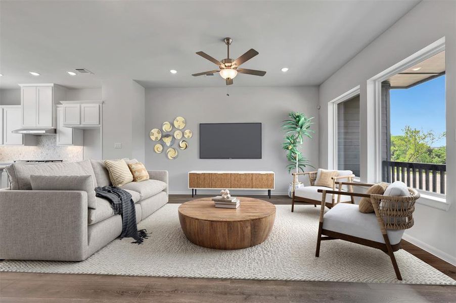 Open-concept living space featuring wood-finish flooring, recessed lighting, and a ceiling fan