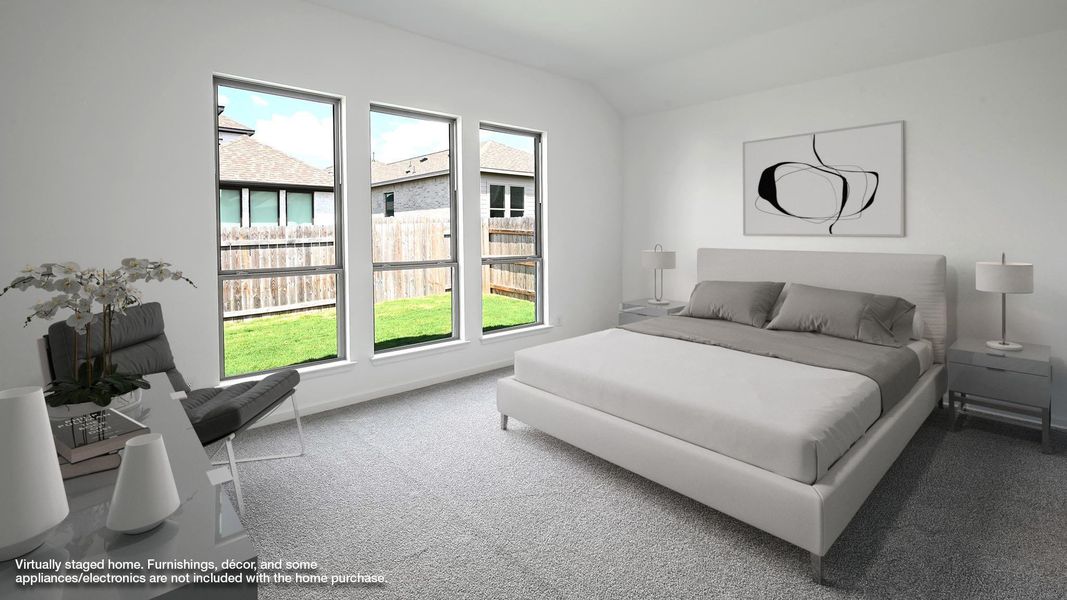 Carpeted bedroom with lofted ceiling and baseboards Carpeted bedroom with lofted ceiling and baseboards