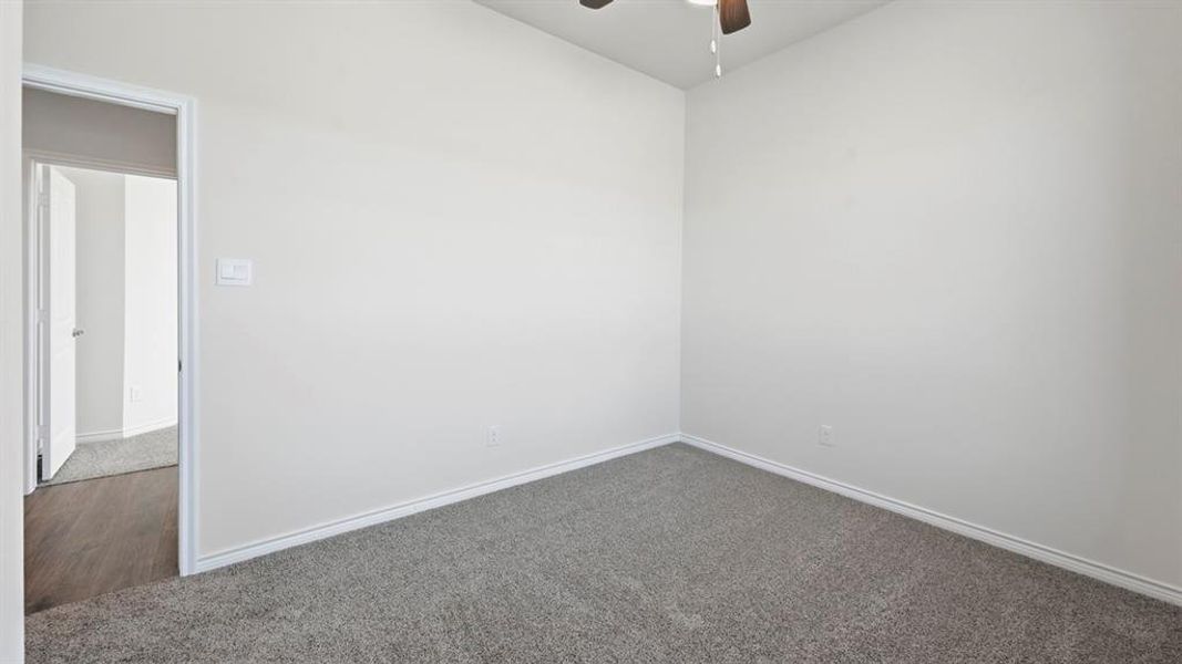 Spare room with carpet floors and ceiling fan Spare room with carpet floors and ceiling fan