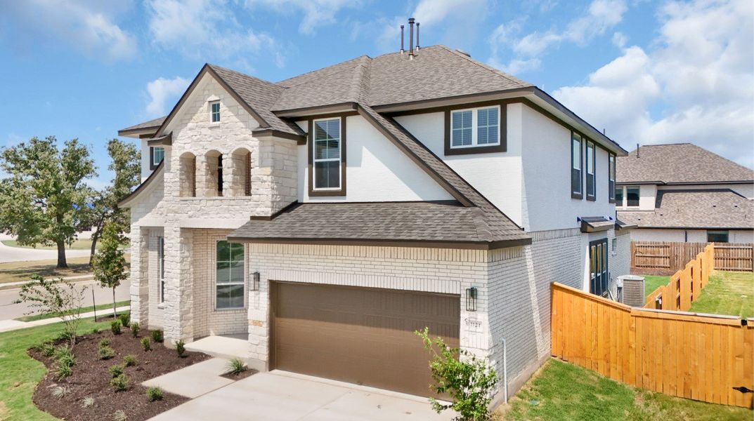 Front exterior of a new home in Lariat, Liberty Hill, TX, highlighting curb appeal (Image 27). Front exterior of a new home in Lariat, Liberty Hill, TX, highlighting curb appeal (Image 27).