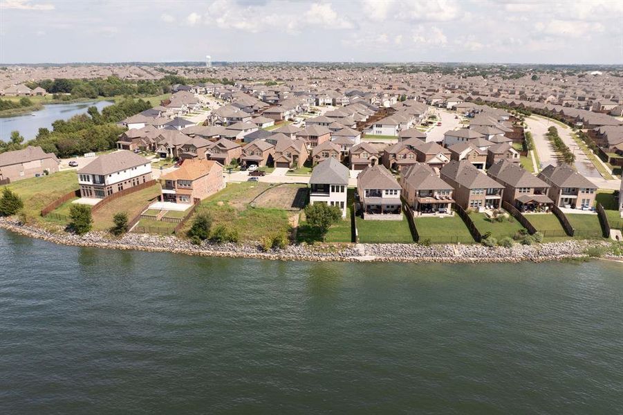 Aerial perspective of suburban area featuring a large body of water