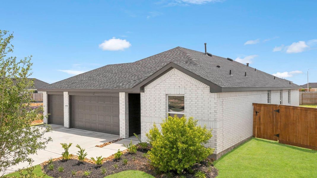 Front exterior of a new home in Sunterra Lakes, Brookshire, TX, highlighting curb appeal (Image 2). Front exterior of a new home in Sunterra Lakes, Brookshire, TX, highlighting curb appeal (Image 2).