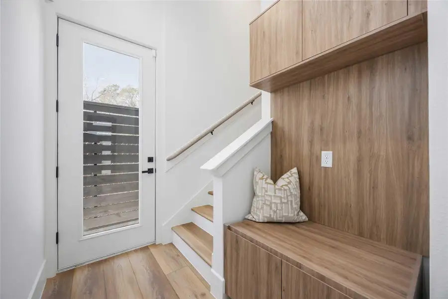 A thoughtfully placed mudroom near the entry adds everyday convenience.