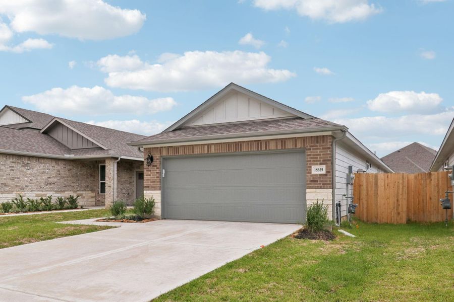 Front exterior of a new home in Landing Meadows - Traditional Series, New Caney, TX, highlighting curb appeal (Image 22). Front exterior of a new home in Landing Meadows - Traditional Series, New Caney, TX, highlighting curb appeal (Image 22).