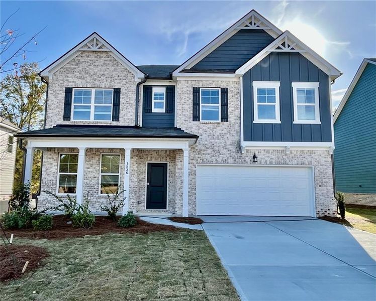 Front exterior of a new home in Kingsmere Estates, Loganville, GA, highlighting curb appeal (Image 1).