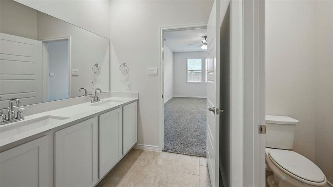 Bathroom with double vanity and light carpet Bathroom with double vanity and light carpet