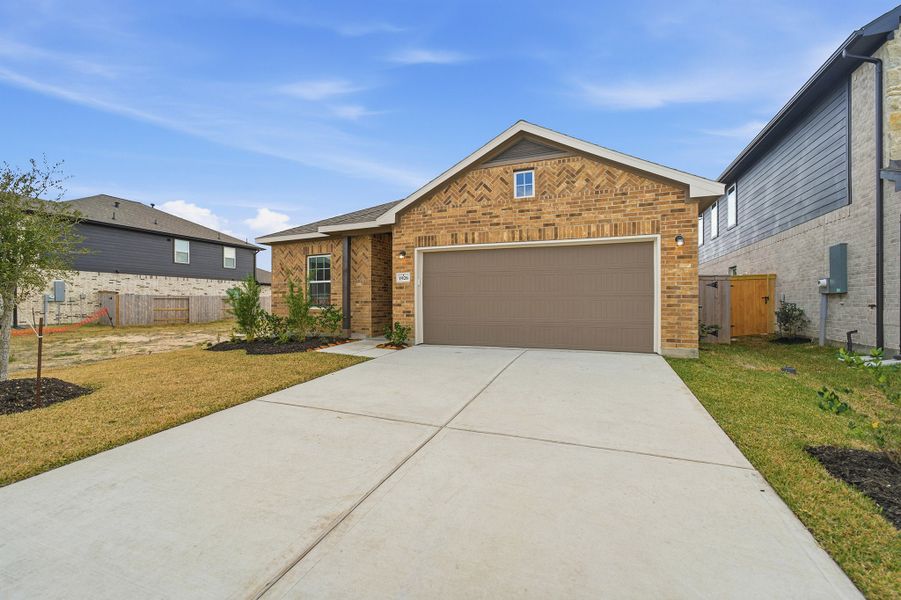 Front exterior of a new home in Windrose Green, Angleton, TX, highlighting curb appeal (Image 16). Front exterior of a new home in Windrose Green, Angleton, TX, highlighting curb appeal (Image 16).
