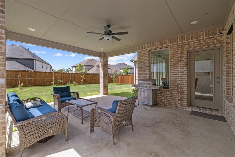 View of patio / terrace with a grill, a fenced backyard, ceiling fan, and an outdoor hangout area