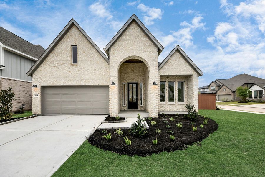Front exterior of a new home in 50' Traditional Homes at Elyson, Katy, TX, highlighting curb appeal (Image 19). Front exterior of a new home in 50' Traditional Homes at Elyson, Katy, TX, highlighting curb appeal (Image 19).