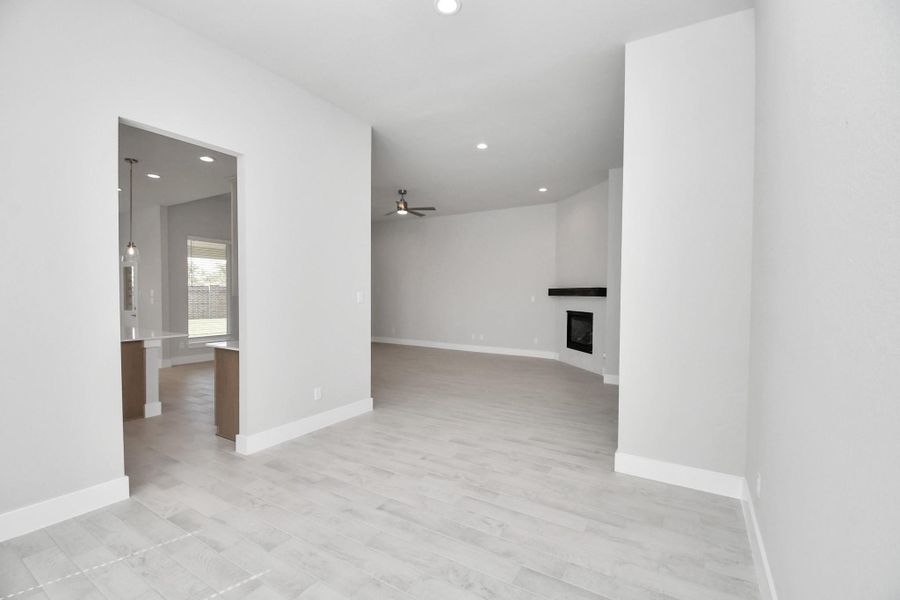 Make memories gathered around the table with your family and friends! This spacious dining room features elegant flooring, custom paint, and adjacent to family room and kitchen for open concept feel. Sample photo of completed home with similar floor plan. Actual colors and selections may vary.