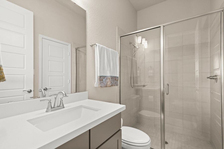 Bathroom featuring vanity and a stall shower Bathroom featuring vanity and a stall shower