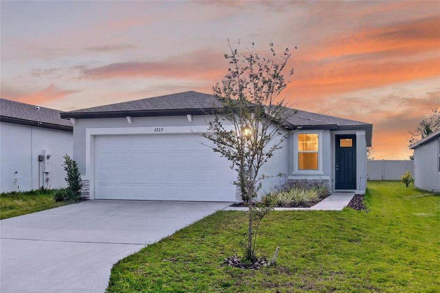 Front exterior of a new home in Park East, Plant City, FL, highlighting curb appeal (Image 24). Front exterior of a new home in Park East, Plant City, FL, highlighting curb appeal (Image 24).