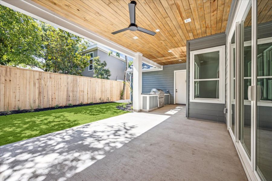 Back covered porch with gas grill,  fan and wood ceiling