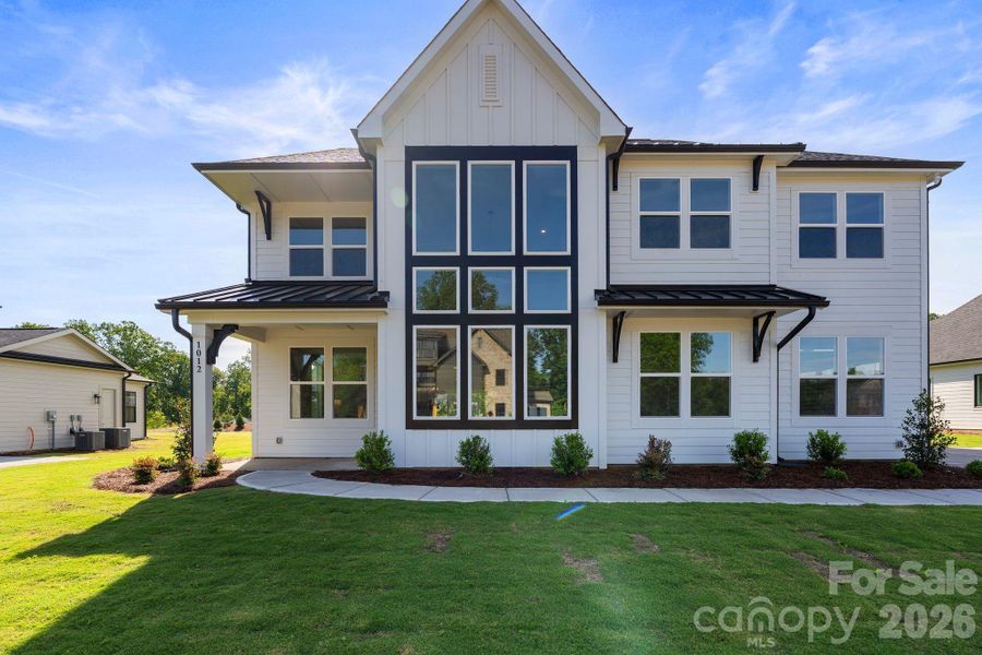 Front exterior of a new home in Bluffs at Wesley Chapel, Waxhaw, NC, highlighting curb appeal (Image 2). Front exterior of a new home in Bluffs at Wesley Chapel, Waxhaw, NC, highlighting curb appeal (Image 2).